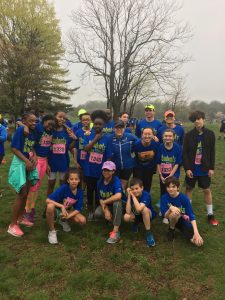 Student running team posing as a group