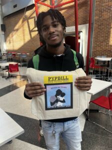 Anthony Spady Senior of the Month smiling holding Playwright bill