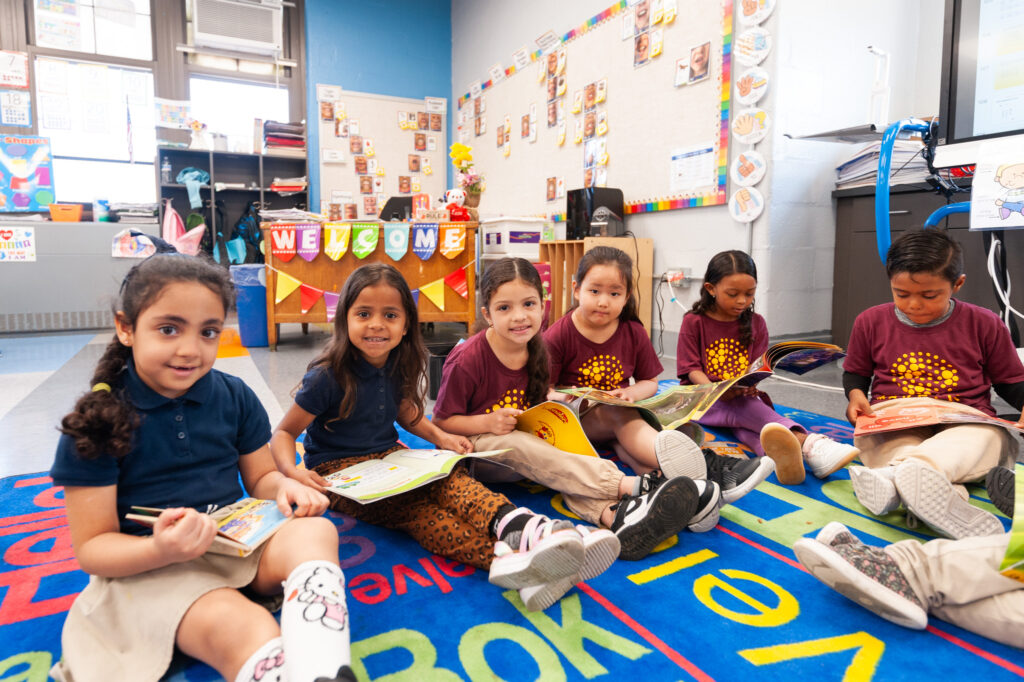 Prek kids on rug with books